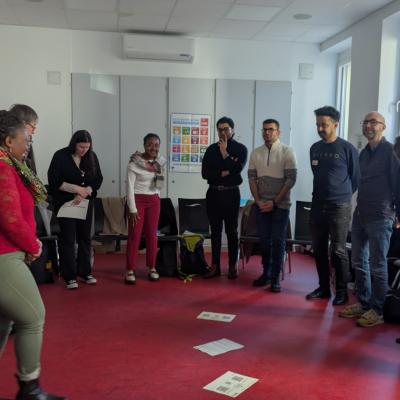 Eine Gruppe von Menschen steht im Halbkreis in einem Raum.