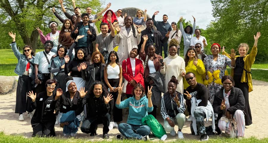 On this picture you can see a group of people (international students from countries in Africa, Asia, and Latin America) that seem to be happy and cheering 